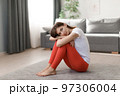 Woman sitting on floor after workout 97306004