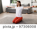 Woman using dumbbells for workout 97306008