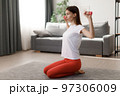 Woman training with dumbbells 97306009