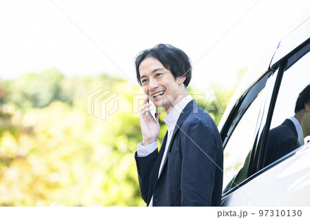 男性　スマホ　電話　屋外　車　ビジネス 97310130