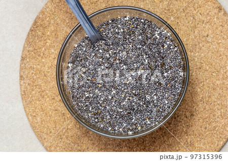Healthy and diet food, Chia seeds or superfood in bowl with spoon on cardboard texture background 97315396