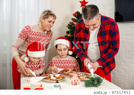 Cute little boyss bake homemade festive gingerbreads. 97317451