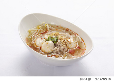 Thai style noodle in Tom Yum soup with meat ball and chicken on white background. 97320910