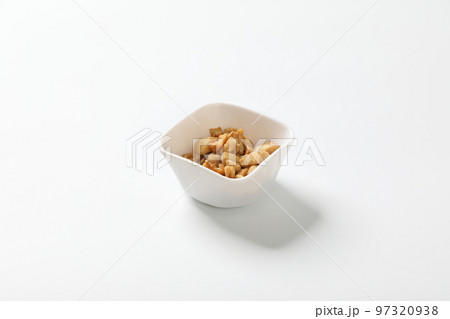 Delicious fat food, fried greaves pork in a bowl on white background. Delicious fat food, fried greaves pork in a bowl on white background. 97320938