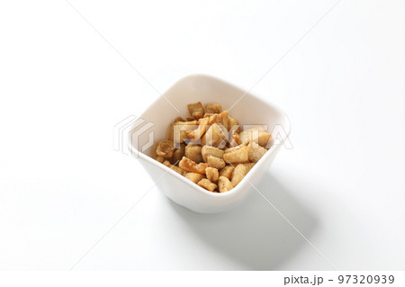 Delicious fat food, fried greaves pork in a bowl on white background. Delicious fat food, fried greaves pork in a bowl on white background. 97320939