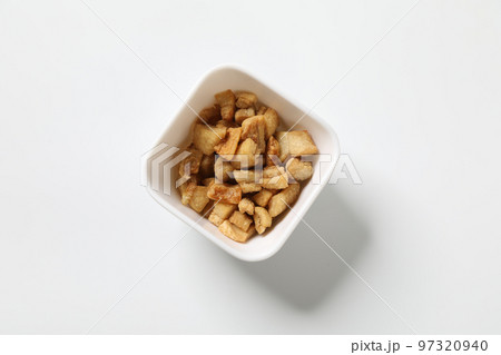 Delicious fat food, fried greaves pork in a bowl on white background. Delicious fat food, fried greaves pork in a bowl on white background. 97320940