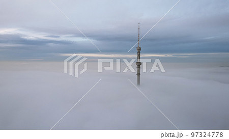 The TV tower looks out of the clouds at sunset. The TV tower looks out of the clouds at sunset. 97324778