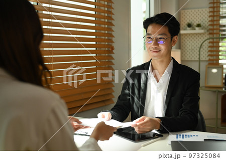 Back view of candidate woman having job interview with recruitment manager. Employment and recruitment concept Back view of candidate woman having job interview with recruitment manager. Employment and recruitment concept 97325084