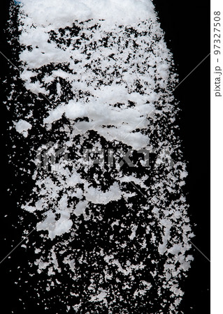 Photo image of falling down snow, heavy big small size snows. Freeze shot on black background isolated overlay. Fluffy White snowflakes splash cloud in mid air. Real Snow high speed shutter 97327508