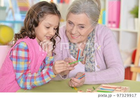 grandmother with granddaughter counting with sticks grandmother with granddaughter counting with sticks 97329917