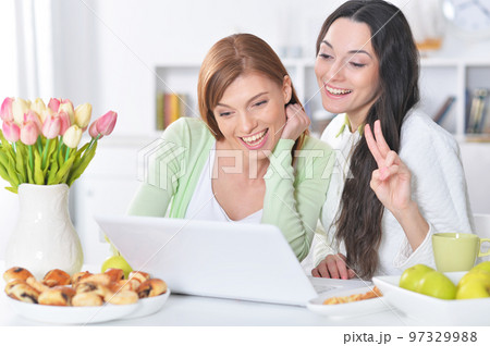 two female friends at desk two female friends at desk 97329988
