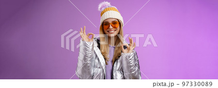 Everything fine thanks. Charming flirty blond confident woman in silver stylish jacket sunglasses winter hat show okay no problem ok gesture smiling affirmative, liking awesome day purple background Everything fine thanks. Charming flirty blond confident woman in silver stylish jacket sunglasses winter hat show okay no problem ok gesture smiling affirmative, liking awesome day purple background 97330089