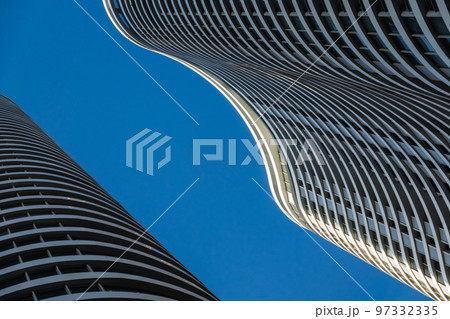 Curvy skyscrapers against blue sky Curvy skyscrapers against blue sky 97332335