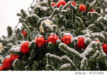 Red balls on a street Christmas tree 97332882