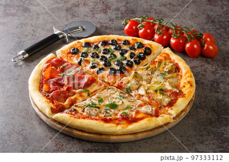 Homemade pizza four seasons with tomatoes, mozzarella, mushrooms, artichokes, ham and olives close-up. Horizontal 97333112