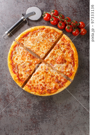 Authentic New York City Italian style pizzeria pizza pie closeup on the board. Vertical top view 97333136