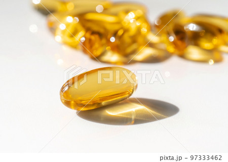 Oil filled capsules on the white background 97333462
