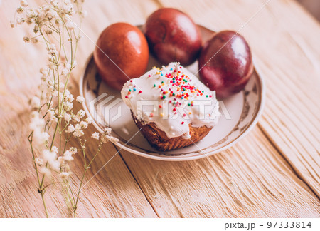 Easter table with traditional Easter cakes and Easter eggs with blossoming tree branch 97333814