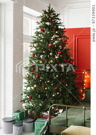 Beautiful Christmas tree with gifts in the bedroom Beautiful Christmas tree with gifts in the bedroom 97339901