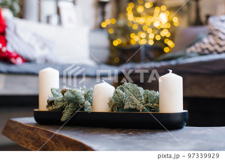 White candles and pine branches in Christmas home decor 97339929