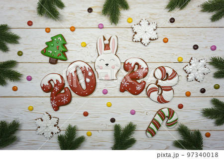 Gingerbread cookies are laid out on a wooden table. Gingerbread cookies are laid out on a wooden table. 97340018
