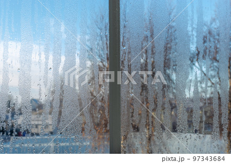 Heavily dewy or misty window during the frosty season Heavily dewy or misty window during the frosty season 97343684