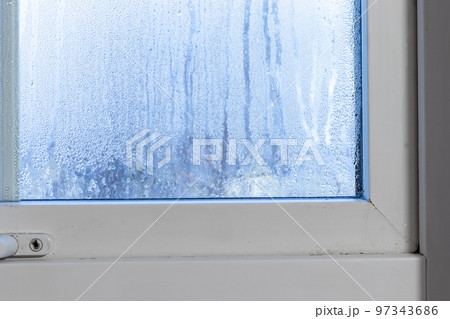 Condensation on the window inside the house. Condensation on the window inside the house. 97343686