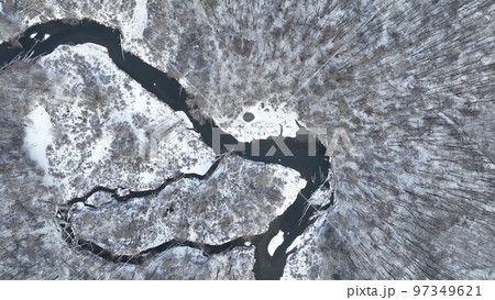 River delta floodplain winter snow meander drone aerial inland video shot in sandy sand alluvium freezing cold frost, benches forest and lowlands wetland swamp, quadcopter view flying fly flight show River delta floodplain winter snow meander drone aerial inland video shot in sandy sand alluvium freezing cold frost, benches forest and lowlands wetland swamp, quadcopter view flying fly flight show 97349621
