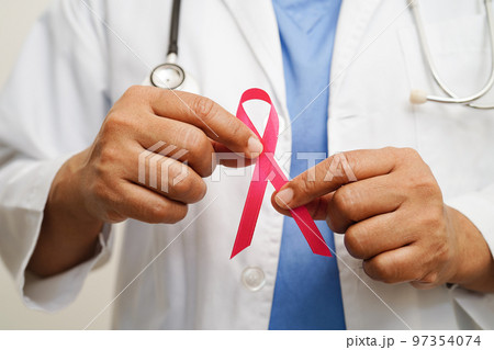 Asian woman doctor with pink ribbon, World Breast Cancer Day at October. 97354074