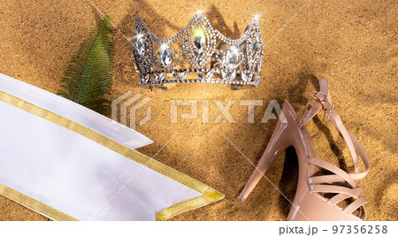 Diamond Crown, High heel shoes, Sash for Princess Miss Pageant Beauty Contest on Sand Beach in Tropical Island beautiful summer sun on golden find sand, studio shot copy space Diamond Crown, High heel shoes, Sash for Princess Miss Pageant Beauty Contest on Sand Beach in Tropical Island beautiful summer sun on golden find sand, studio shot copy space 97356258