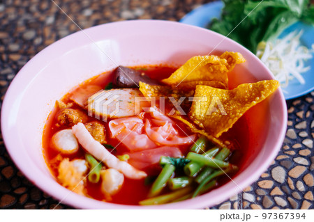Close up of noodle in pink broth ( Yentafo ) Close up of noodle in pink broth ( Yentafo ) 97367394