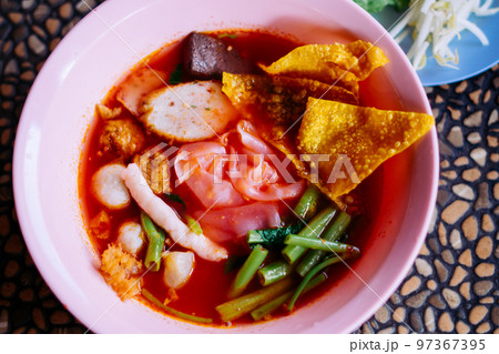 Close up of noodle in pink broth ( Yentafo ) 97367395