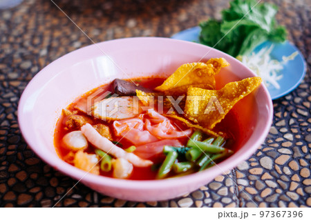 Close up of noodle in pink broth ( Yentafo ) 97367396