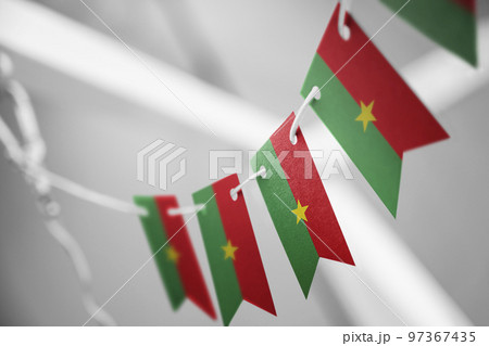 A garland of Burkina Faso national flags on an abstract blurred background A garland of Burkina Faso national flags on an abstract blurred background 97367435