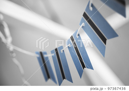 A garland of Botswana national flags on an abstract blurred background A garland of Botswana national flags on an abstract blurred background 97367436