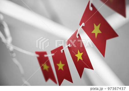 A garland of Vietnam national flags on an abstract blurred background 97367437
