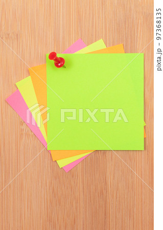 Colored Sticky Notes Pinned to the Wooden Message Board Colored Sticky Notes Pinned to the Wooden Message Board 97368135