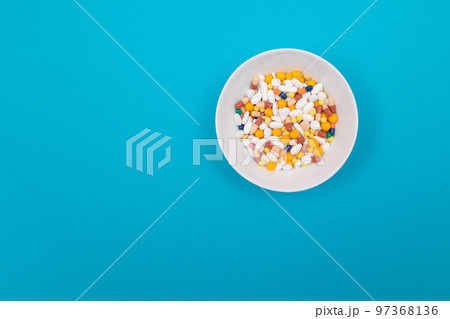 Pharmaceutical Industry and Medicinal Products - Colored Pills in White Dish 97368136