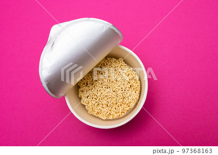 Opened Package with Uncooked Instant Noodles on Pink Background Opened Package with Uncooked Instant Noodles on Pink Background 97368163