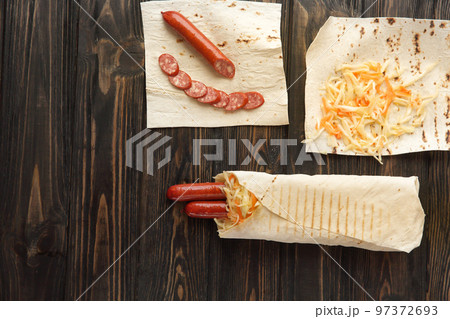close up. preparation of sausage in lavash .photo with copy space close up. preparation of sausage in lavash .photo with copy space 97372693