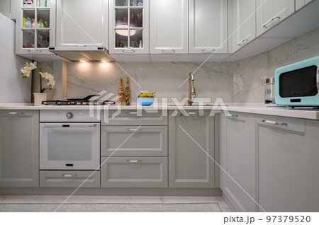 New light grey modern well designed kitchen interior, front view New light grey modern well designed kitchen interior, front view 97379520