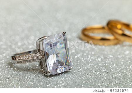 Will you marry me. Engagement ring and two wedding rings on silver glitter background. Engagement marriage proposal wedding concept. St. Valentine's Day postcard. Banner on valentines day. Copy space Will you marry me. Engagement ring and two wedding rings on silver glitter background. Engagement marriage proposal wedding concept. St. Valentine's Day postcard. Banner on valentines day. Copy space 97383674