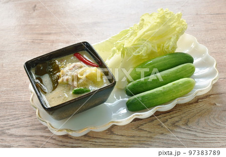 spicy Indo-Pacific king mackerel fish and chili sauce dipping fresh vegetable on plate 97383789