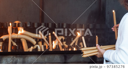 Person offering Candles at Sanctuary of Fatima - Fatima, Portugal 97385276
