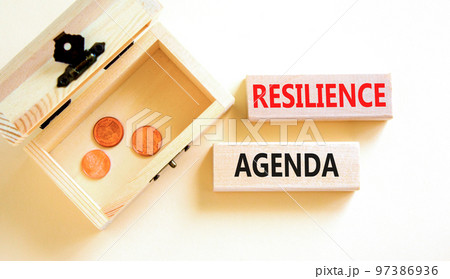Resilience agenda symbol. Concept word Resilience agenda typed on wooden blocks. Beautiful white table white background. Wooden chest with coins. Business and resilience agenda concept. Copy space. 97386936
