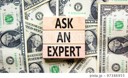 Ask an expert symbol. Concept words Ask an expert on wooden blocks on a beautiful background from dollar bills. Business and ask an expert concept. Copy space. Ask an expert symbol. Concept words Ask an expert on wooden blocks on a beautiful background from dollar bills. Business and ask an expert concept. Copy space. 97386955