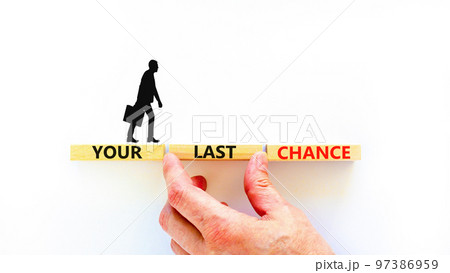 Time to your last chance symbol. Concept words Your last chance on wooden blocks on a beautiful white table white background. Businessman hand. Business and your last chance concept. Copy space. 97386959