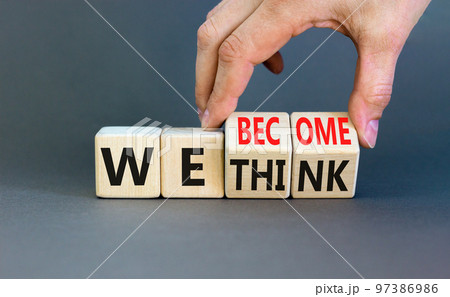 We become or think symbol. Concept word We think We become on wooden cubes. Beautiful grey table grey background. Businessman hand. Business we become or think concept. Copy space. 97386986