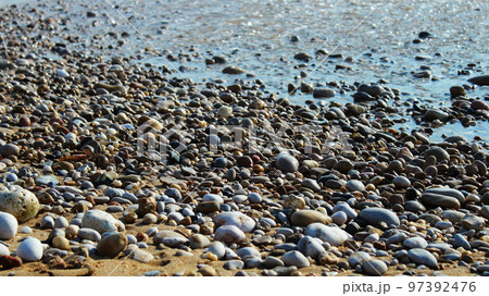 pebbles washed by the waves on the beach pebbles washed by the waves on the beach 97392476