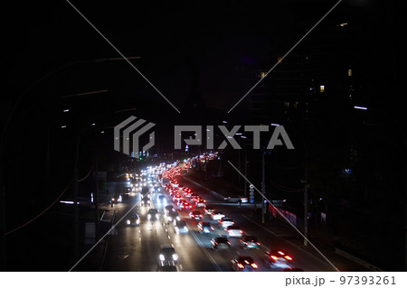 Kyiv, Ukraine - December 16, 2022: Blackout in the Ukrainian capital Kyiv. Capital streets without street lighting. Only the lights of passing cars are visible 97393261